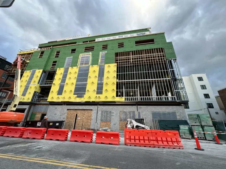 Building exterior wrapped with DensGlass sheathing and Blueskin air barrier at 33A Street