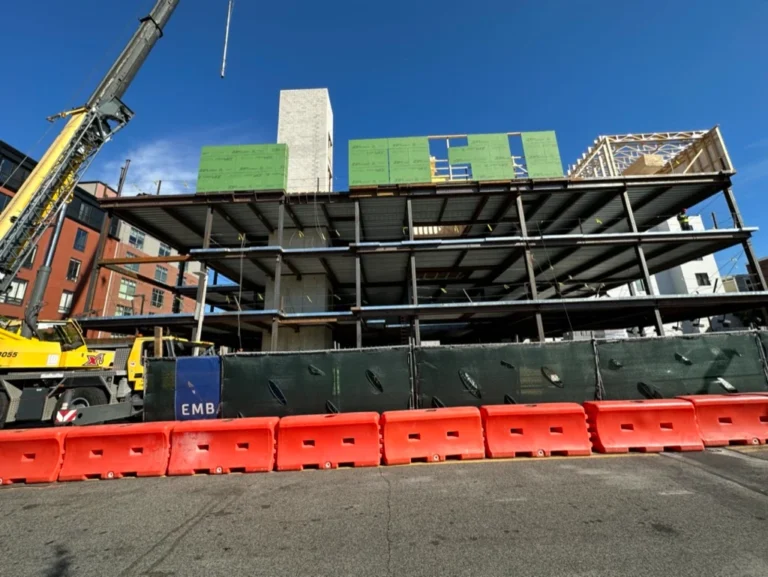 Exterior wrapping progress across three stories at 33A Street, South Boston