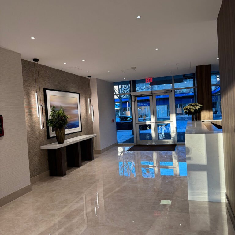 Finished lobby with blue board and plaster walls and ceiling at Brook House Condominiums